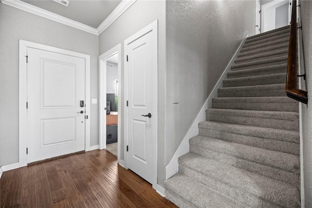 1320 Lariat Dr, Centerton, AR 72719 - foyer entrance with crown molding, dark wood finished floors, stairs, and baseboards