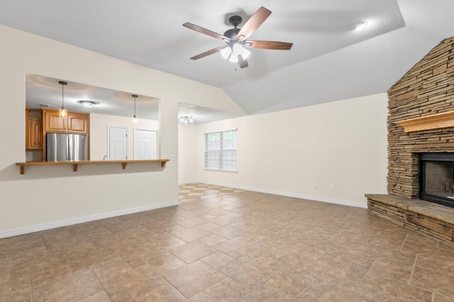 12305 Tyson Rd, Lowell, AR 72745 - unfurnished living room featuring vaulted ceiling, ceiling fan, and a fireplace