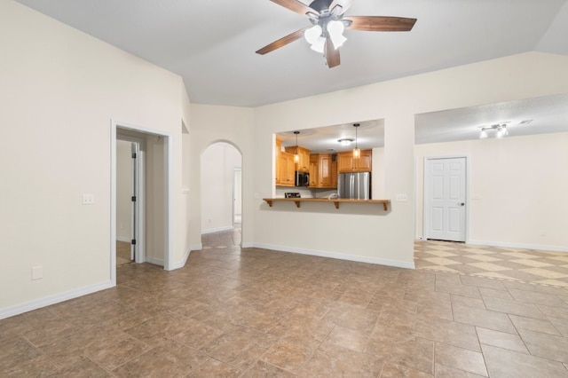 12305 Tyson Rd, Lowell, AR 72745 - unfurnished living room featuring arched walkways and ceiling fan