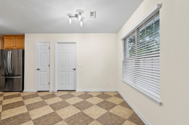 12305 Tyson Rd, Lowell, AR 72745 - unfurnished room with a textured ceiling and light flooring