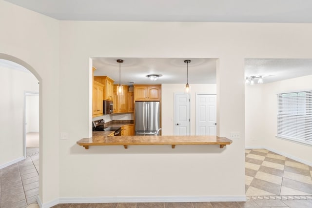 12305 Tyson Rd, Lowell, AR 72745 - kitchen featuring freestanding refrigerator, black range with electric cooktop, arched walkways, a peninsula, and decorative light fixtures