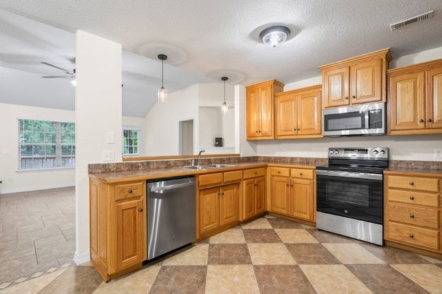 12305 Tyson Rd, Lowell, AR 72745 - kitchen with appliances with stainless steel finishes, vaulted ceiling, a ceiling fan, dark countertops, and decorative light fixtures