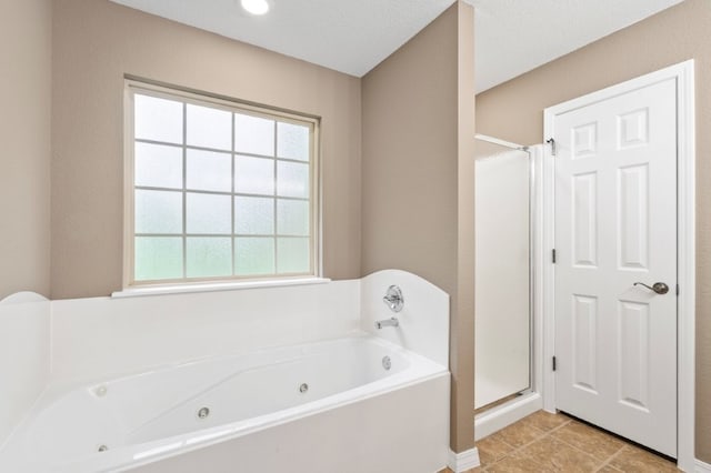 12305 Tyson Rd, Lowell, AR 72745 - full bath with a jetted tub, a shower stall, and tile patterned floors