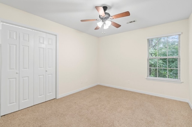 12305 Tyson Rd, Lowell, AR 72745 - unfurnished bedroom with carpet flooring, a closet, and a ceiling fan