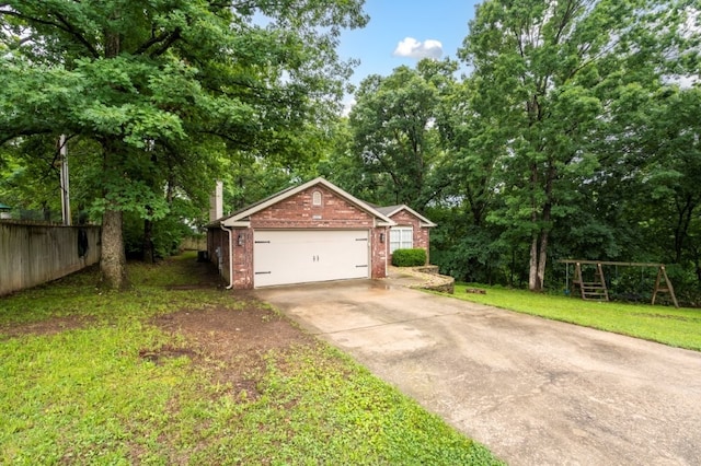 12305 Tyson Rd, Lowell, AR 72745 - view of front of property featuring brick siding, concrete driveway, a garage, and view of scattered trees