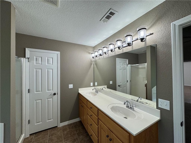 12305 Tyson Rd, Lowell, AR 72745 - full bath featuring a stall shower, double vanity, a textured ceiling, and tile patterned flooring