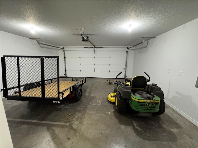12305 Tyson Rd, Lowell, AR 72745 - garage featuring a garage door opener and baseboards