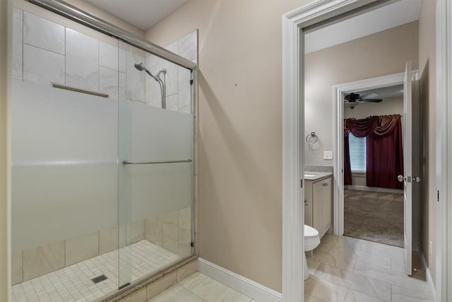 4465 Champagne Dr, Springdale, AR 72764 - bathroom featuring a stall shower, vanity, baseboards, toilet, and ceiling fan