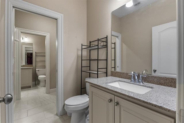 4465 Champagne Dr, Springdale, AR 72764 - bathroom featuring toilet, vanity, and baseboards