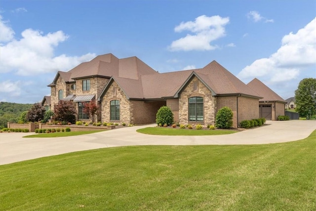 4465 Champagne Dr, Springdale, AR 72764 - view of front of home featuring stone siding, curved driveway, and a front yard