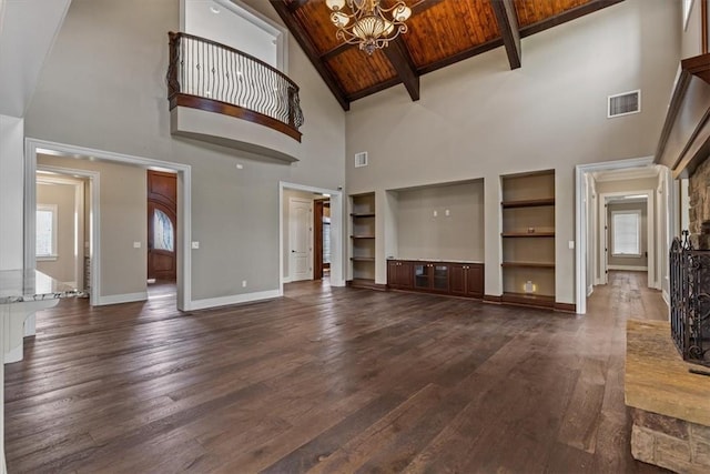 4465 Champagne Dr, Springdale, AR 72764 - unfurnished living room featuring high vaulted ceiling, a chandelier, built in features, baseboards, and dark wood-type flooring