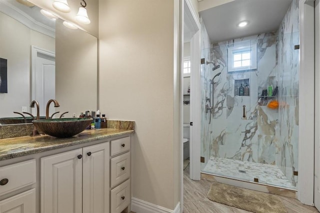 4465 Champagne Dr, Springdale, AR 72764 - bathroom featuring a marble finish shower, vanity, and baseboards