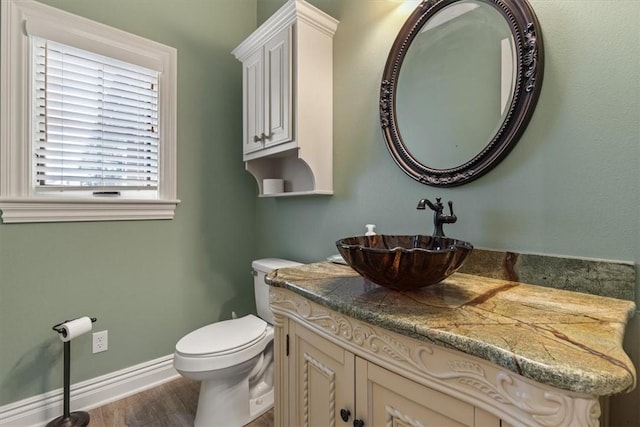 4465 Champagne Dr, Springdale, AR 72764 - bathroom featuring vanity, wood finished floors, toilet, and baseboards