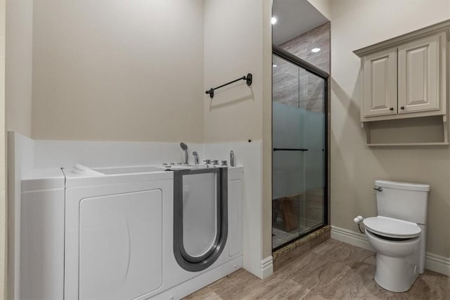 4465 Champagne Dr, Springdale, AR 72764 - bathroom featuring a stall shower, baseboards, toilet, and a bath