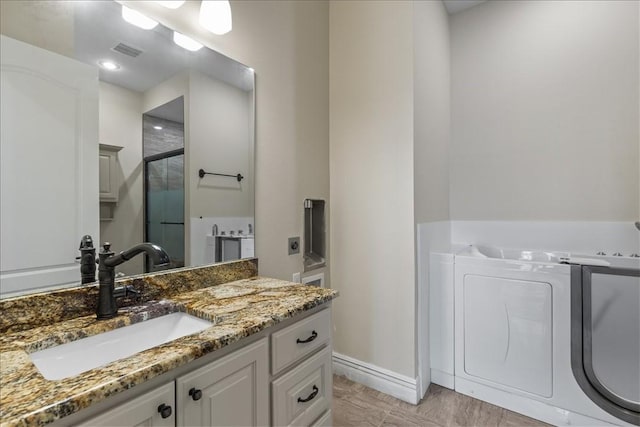 4465 Champagne Dr, Springdale, AR 72764 - bathroom featuring a stall shower, vanity, and baseboards