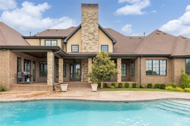 4465 Champagne Dr, Springdale, AR 72764 - back of property featuring a patio, an outdoor pool, a chimney, and stone siding