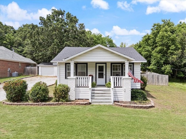626 Ash St, Fayetteville, AR 72703 - bungalow-style house featuring covered porch, an outbuilding, roof with shingles, a detached garage, and central AC
