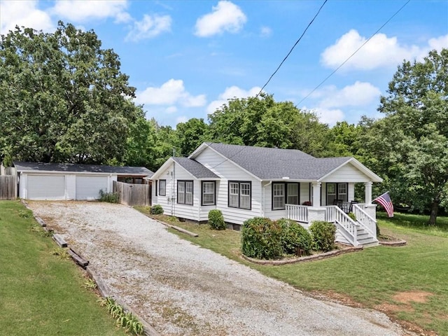626 Ash St, Fayetteville, AR 72703 - ranch-style house featuring a porch, an outdoor structure, gravel driveway, a detached garage, and a shingled roof