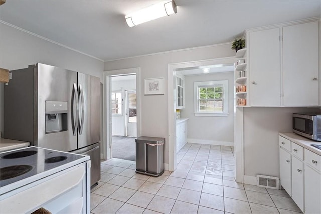 626 Ash St, Fayetteville, AR 72703 - kitchen featuring stainless steel microwave, white cabinets, baseboards, light countertops, and open shelves