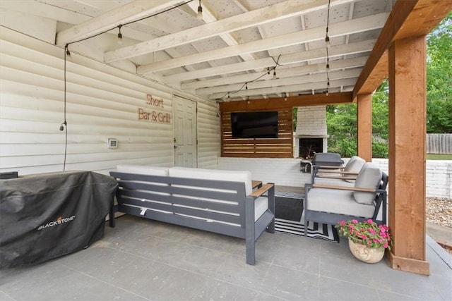 626 Ash St, Fayetteville, AR 72703 - view of patio with an outdoor living space with a fireplace