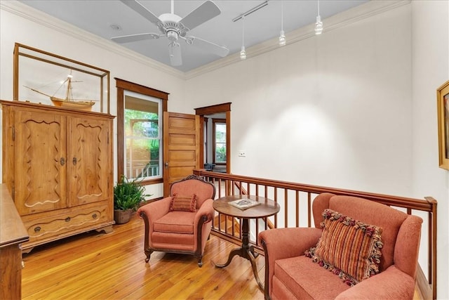 11 Hilton St, Eureka Springs, AR 72632 - sitting room with ornamental molding, light wood-style floors, and ceiling fan