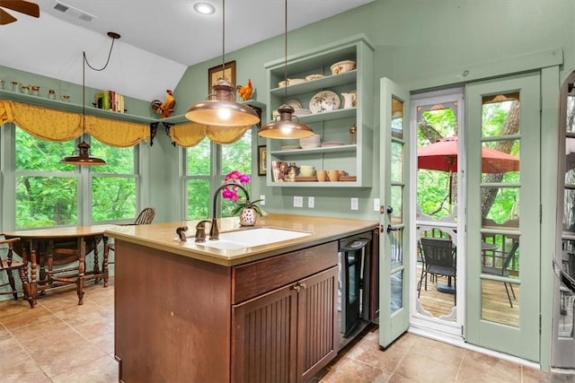 11 Hilton St, Eureka Springs, AR 72632 - kitchen featuring plenty of natural light, vaulted ceiling, light countertops, beverage cooler, and decorative light fixtures