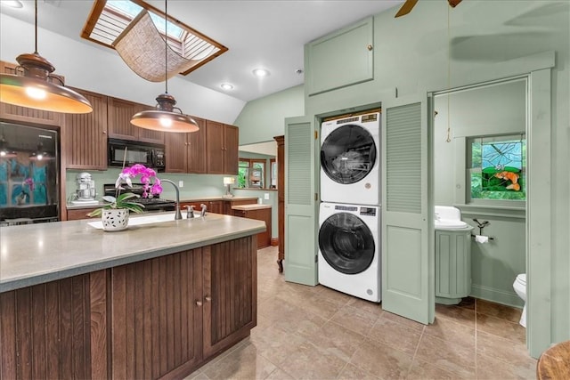 11 Hilton St, Eureka Springs, AR 72632 - laundry area with stacked washer / dryer, a skylight, and plenty of natural light