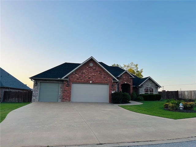 5749 S Chanberry Ln, Rogers, AR 72758 - view of front of property with a garage, concrete driveway, brick siding, and roof with shingles