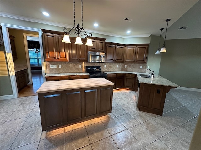 5749 S Chanberry Ln, Rogers, AR 72758 - kitchen featuring stainless steel microwave, black range with electric cooktop, a sink, a peninsula, and backsplash