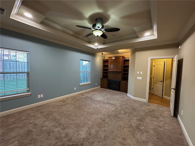 5749 S Chanberry Ln, Rogers, AR 72758 - unfurnished living room featuring ornamental molding, a raised ceiling, carpet floors, ceiling fan, and baseboards