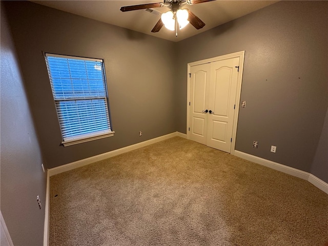 5749 S Chanberry Ln, Rogers, AR 72758 - unfurnished bedroom featuring carpet floors, baseboards, and ceiling fan
