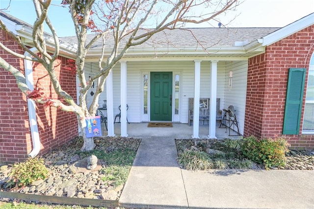 925 Lowell Ave, Cave Springs, AR 72718 - view of exterior entry with a porch, brick siding, and roof with shingles