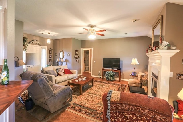 925 Lowell Ave, Cave Springs, AR 72718 - living area featuring wood finished floors, ceiling fan, a fireplace, and baseboards