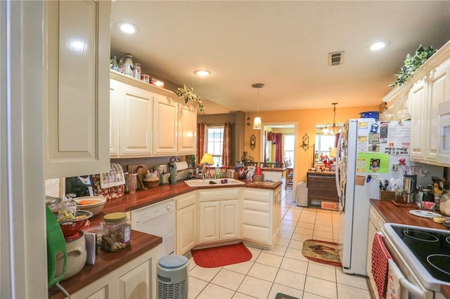 925 Lowell Ave, Cave Springs, AR 72718 - kitchen featuring white appliances, light tile patterned floors, a sink, a peninsula, and recessed lighting