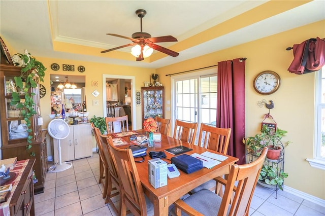 925 Lowell Ave, Cave Springs, AR 72718 - dining space featuring a tray ceiling, plenty of natural light, light tile patterned flooring, and a ceiling fan