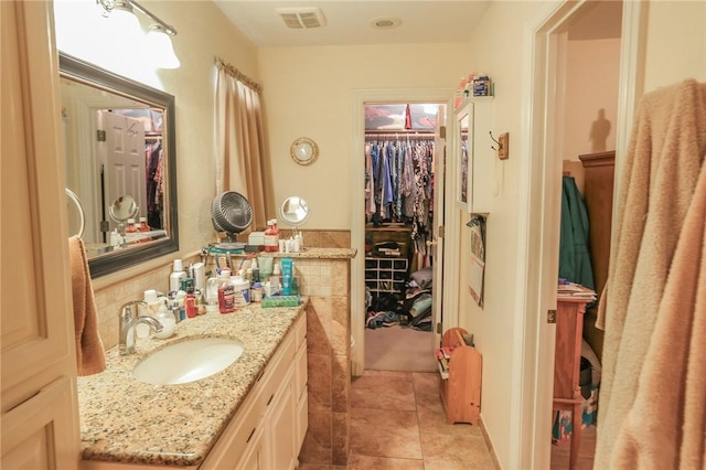 925 Lowell Ave, Cave Springs, AR 72718 - bathroom featuring tile patterned floors, vanity, and a spacious closet