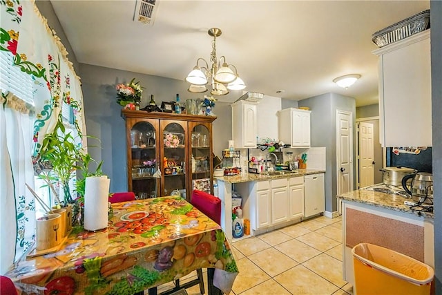 814 Colley St, Lowell, AR 72745 - kitchen featuring white cabinets, a chandelier, light tile patterned floors, dishwasher, and light stone countertops