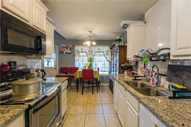 814 Colley St, Lowell, AR 72745 - kitchen with stainless steel electric stove, black microwave, a sink, a chandelier, and decorative backsplash