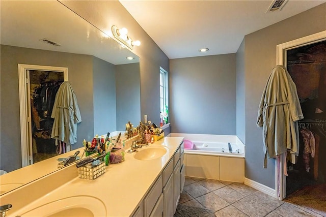 814 Colley St, Lowell, AR 72745 - full bath with double vanity, a whirlpool tub, tile patterned floors, and a walk in closet