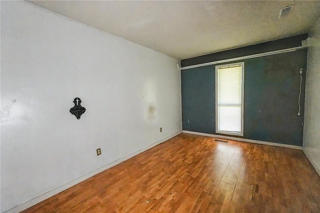 10703 Thunder Rd, Fayetteville, AR 72701 - spare room featuring hardwood / wood-style flooring and baseboards