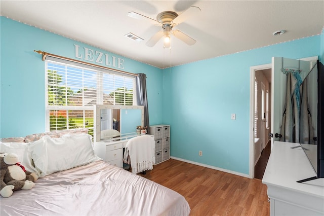 1503 W Kelley Dr, Rogers, AR 72756 - bedroom featuring wood finished floors, a ceiling fan, and baseboards