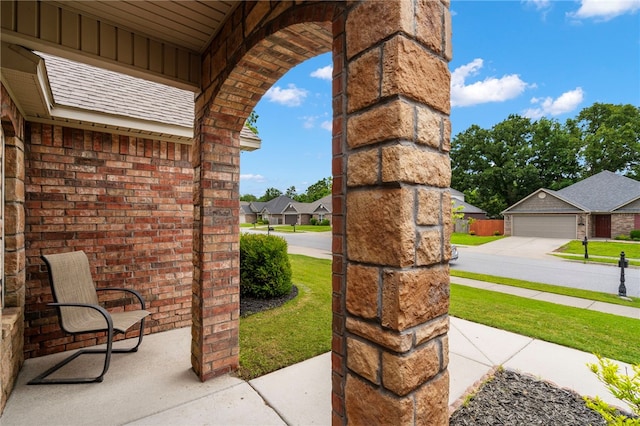 1503 W Kelley Dr, Rogers, AR 72756 - view of patio / terrace featuring a residential view, a garage, and concrete driveway