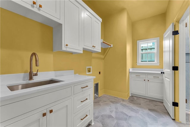1559 W Cassi Aly, Fayetteville, AR 72701 - washroom with cabinet space, electric dryer hookup, washer hookup, light stone finish flooring, and baseboards