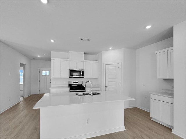 200 Greer St, Pea Ridge, AR 72751 - kitchen featuring stainless steel appliances, a sink, light wood-style floors, light countertops, and recessed lighting
