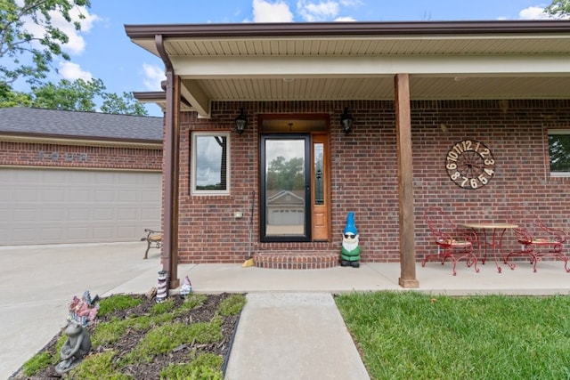 4 Torrido Ln, Bella Vista, AR 72715 - property entrance with brick siding, an attached garage, and driveway
