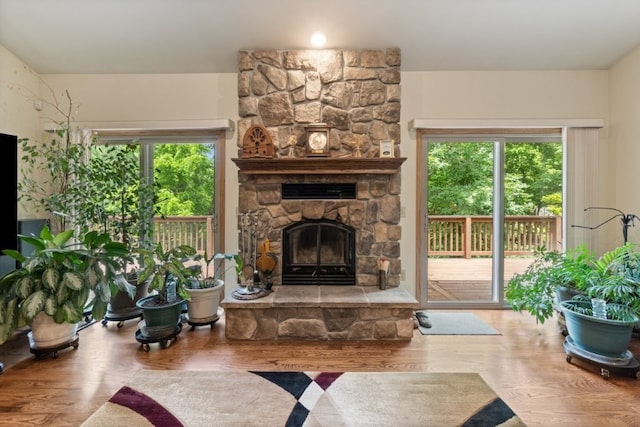 4 Torrido Ln, Bella Vista, AR 72715 - living area featuring a stone fireplace and wood finished floors