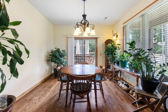 4 Torrido Ln, Bella Vista, AR 72715 - dining room featuring baseboards, wood finished floors, and a chandelier
