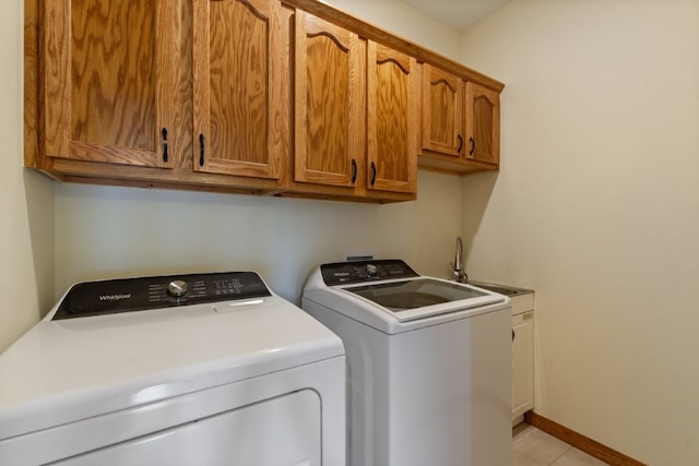 4 Torrido Ln, Bella Vista, AR 72715 - washroom with washing machine and dryer, cabinet space, light tile patterned floors, and baseboards
