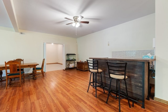 4 Torrido Ln, Bella Vista, AR 72715 - dining area featuring a bar, ceiling fan, and wood finished floors