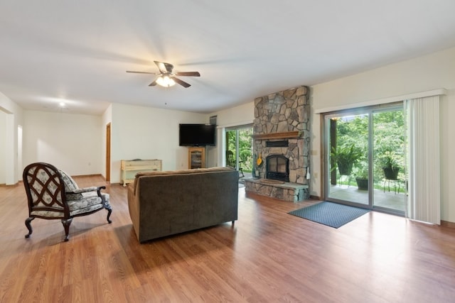 4 Torrido Ln, Bella Vista, AR 72715 - living room with a stone fireplace, ceiling fan, and wood finished floors